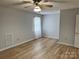 Clean bedroom with hardwood floors, neutral walls, a window with blinds, and ceiling fan at 1228 Hidden Creek Cir, Hickory, NC 28602