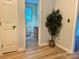 Hallway view shows neutral walls, hardwood floors, closet, and leads to bathroom with window at 1228 Hidden Creek Cir, Hickory, NC 28602