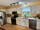 Bright kitchen featuring stainless steel appliances, granite countertops, and white cabinets at 1228 Hidden Creek Cir, Hickory, NC 28602