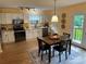 Bright kitchen and dining space with modern appliances, white cabinetry, and backyard access at 1228 Hidden Creek Cir, Hickory, NC 28602
