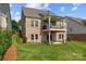 This home features a well-kept backyard with a brick house, lawn, and outdoor patio and deck at 1280 Winged Foot Dr, Denver, NC 28037