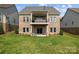 Exterior backyard shot shows a beautiful brick home with a second-story balcony at 1280 Winged Foot Dr, Denver, NC 28037
