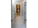 Long bathroom hallway features white cabinets, granite countertops, and tiled flooring at 1280 Winged Foot Dr, Denver, NC 28037