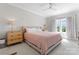 This bedroom has soft, natural light, neutral paint, and carpeted floors for a calming and relaxing experience at 1280 Winged Foot Dr, Denver, NC 28037