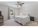 Bedroom featuring a window, ceiling fan, carpeted floors, and a comfortable bed at 1280 Winged Foot Dr, Denver, NC 28037