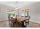 Bright dining room showcasing a large wooden table, ample natural light, and cozy window treatments at 1280 Winged Foot Dr, Denver, NC 28037