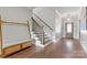 Entryway featuring hardwood floors, staircase with wooden handrail, and a decorative bench at 1280 Winged Foot Dr, Denver, NC 28037