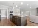 Modern kitchen island with granite countertops, stainless steel appliances, and hardwood floors at 1280 Winged Foot Dr, Denver, NC 28037