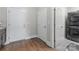 Laundry room featuring gray cabinets, granite countertops, and a stacked washer and dryer at 1280 Winged Foot Dr, Denver, NC 28037