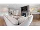 Cozy living room with a large sectional sofa, fireplace with mounted TV, and hardwood floors at 1280 Winged Foot Dr, Denver, NC 28037