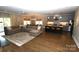 Open-concept living space with hardwood floors and a spacious layout combining kitchen, dining, and living areas at 1280 Winged Foot Dr, Denver, NC 28037