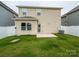Spacious backyard with a concrete patio and green lawn, perfect for outdoor entertaining at 13022 Hill Pine Rd, Midland, NC 28107