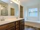 Bright bathroom features a double sink vanity, bathtub and separate glass enclosed shower at 13022 Hill Pine Rd, Midland, NC 28107