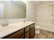 Bathroom features a double sink vanity with warm wood cabinetry at 13022 Hill Pine Rd, Midland, NC 28107