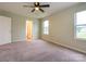 Spacious bedroom featuring a ceiling fan and natural light from two windows at 13022 Hill Pine Rd, Midland, NC 28107