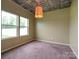 Bright bedroom with two windows, neutral walls, and carpet flooring at 13022 Hill Pine Rd, Midland, NC 28107