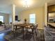 Modern dining room featuring a wooden table set with gray chairs, chandelier lighting, and an open floor plan at 13022 Hill Pine Rd, Midland, NC 28107