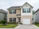 Charming two-story home with a well-kept lawn, flower bed, and attached garage at 13022 Hill Pine Rd, Midland, NC 28107