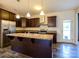 Well-equipped kitchen with a large island, stainless steel appliances, and dark wood cabinetry at 13022 Hill Pine Rd, Midland, NC 28107
