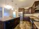 Well-lit kitchen featuring stainless steel appliances, wooden cabinetry, an island with a sink and lots of light at 13022 Hill Pine Rd, Midland, NC 28107
