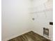 Bright laundry room with wooden vinyl flooring and white wire shelving for optimal storage at 13022 Hill Pine Rd, Midland, NC 28107