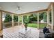 Inviting back porch with comfortable seating, ceiling fan, and view of the backyard at 1315 Charles Ave, Charlotte, NC 28205