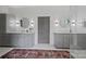 Bright bathroom featuring double vanity, decorative rug, and sleek, modern finishes at 1315 Charles Ave, Charlotte, NC 28205