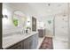 Bright bathroom with double vanity, shiplap accent wall, and glass-enclosed shower at 1315 Charles Ave, Charlotte, NC 28205