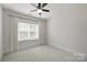 Bright bedroom featuring a ceiling fan, neutral walls, and natural light at 1315 Charles Ave, Charlotte, NC 28205