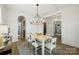 Elegant dining room with modern chandelier, light wood table, and wainscoting at 1315 Charles Ave, Charlotte, NC 28205