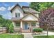 Charming two-story home featuring a welcoming front porch, complemented by lush landscaping and a beautifully maintained lawn at 1315 Charles Ave, Charlotte, NC 28205