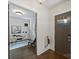 Bright foyer featuring a modern front door, wood floors, and view into a home office at 1315 Charles Ave, Charlotte, NC 28205