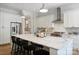 Spacious kitchen island with marble countertop, stainless steel appliances, and white cabinets, offering ample seating at 1315 Charles Ave, Charlotte, NC 28205