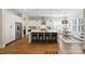 Modern kitchen with stainless steel appliances, a marble island with seating, and an adjacent dining area at 1315 Charles Ave, Charlotte, NC 28205