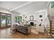 Bright living room featuring a fireplace, hardwood floors, and large windows, seamlessly connecting to outdoor spaces at 1315 Charles Ave, Charlotte, NC 28205