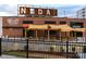 Exterior view of Wooden Robot Brewery, a brick building with outdoor seating under a pergola at 1315 Charles Ave, Charlotte, NC 28205