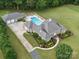 Aerial view showcasing a luxurious home with a pool, spacious garage, and beautifully landscaped backyard at 1340 Canter Ln, York, SC 29745