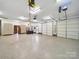 Spacious garage with cabinets, office desk, and multiple garage doors for vehicle or equipment storage at 1340 Canter Ln, York, SC 29745