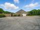 A three-car garage and beautiful landscaping complement the brick home at 1340 Canter Ln, York, SC 29745