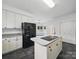 Open kitchen featuring an island cooktop and a refrigerator with water dispenser at 1340 Canter Ln, York, SC 29745