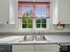 Stainless steel kitchen sink under a window with views of the backyard at 1340 Canter Ln, York, SC 29745