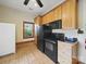 Kitchenette featuring wood cabinets, black appliances, and tile flooring at 1340 Canter Ln, York, SC 29745