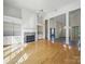 Open-concept living room featuring hardwood floors, a fireplace, built-in shelves, and generous space at 1340 Canter Ln, York, SC 29745