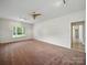 Spacious living room with large window, ceiling fan, and neutral color palette at 1340 Canter Ln, York, SC 29745