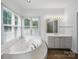 Bright bathroom with jacuzzi tub, tiled shower in mirror view, and natural light at 1340 Canter Ln, York, SC 29745