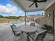 Covered patio featuring a round table with chairs and a beautiful pool view at 1340 Canter Ln, York, SC 29745