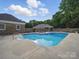 Refreshing in-ground pool with a surrounding brick fence and lush green trees at 1340 Canter Ln, York, SC 29745