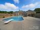 Sparkling in-ground swimming pool with diving board and brick fence at 1340 Canter Ln, York, SC 29745