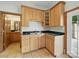 Wet bar featuring wooden cabinets, black countertops, and tile flooring at 1340 Canter Ln, York, SC 29745