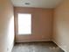 This cozy bedroom features neutral walls and carpet, with a bright window at 13441 Calloway Glen Dr, Charlotte, NC 28273